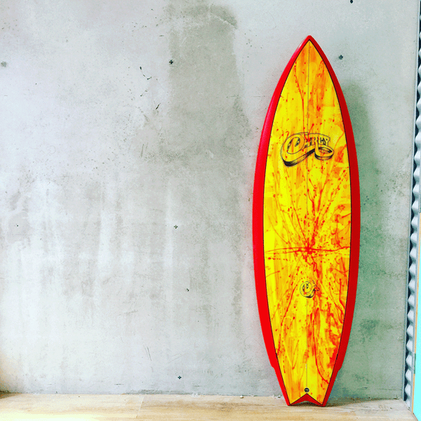 image of the disco twin surfboard with yellow and red surfboard art